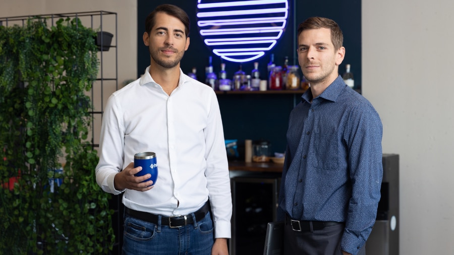 Two people standing next to each other in an office.